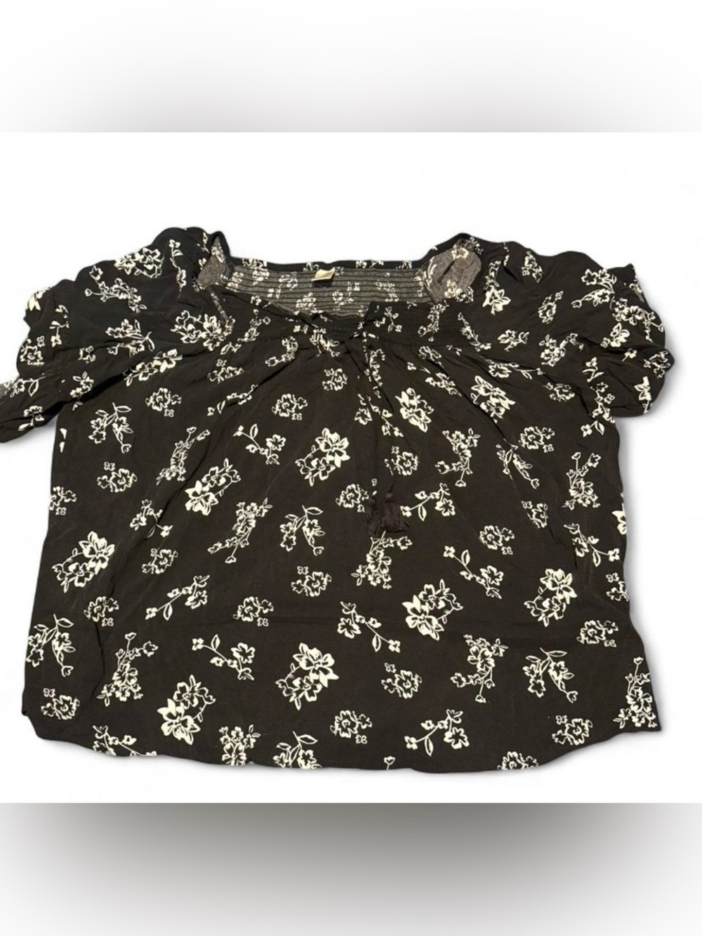 Terra & Sky top features a black and white floral print with ruffle sleeve hems